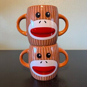 Set of 2 Knitted Sock Monkey Ceramic Dual Handled, Double Sided Mugs - GALERIE